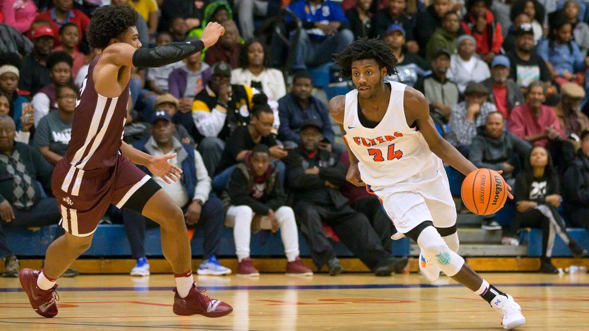 East St. Louis Terrance Hargrove drives against Belleville West Will Shumpert during Friday’s conference game at East St. Louis High School.
