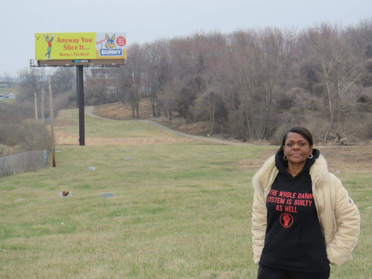 Wanda Brandon is shown at Washington Park Cemetery in St. Louis in 2018, when advertising was still being displayed on billboards along Interstate 70.