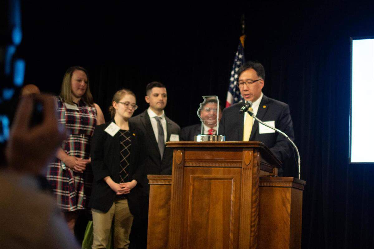 Employees of Rivian, which manufactures the all-electric R1T truck in Normal, receive the award for “Coolest Thing Made in Illinois,” the result of an annual contest hosted by the Illinois Manufacturers’ Association.