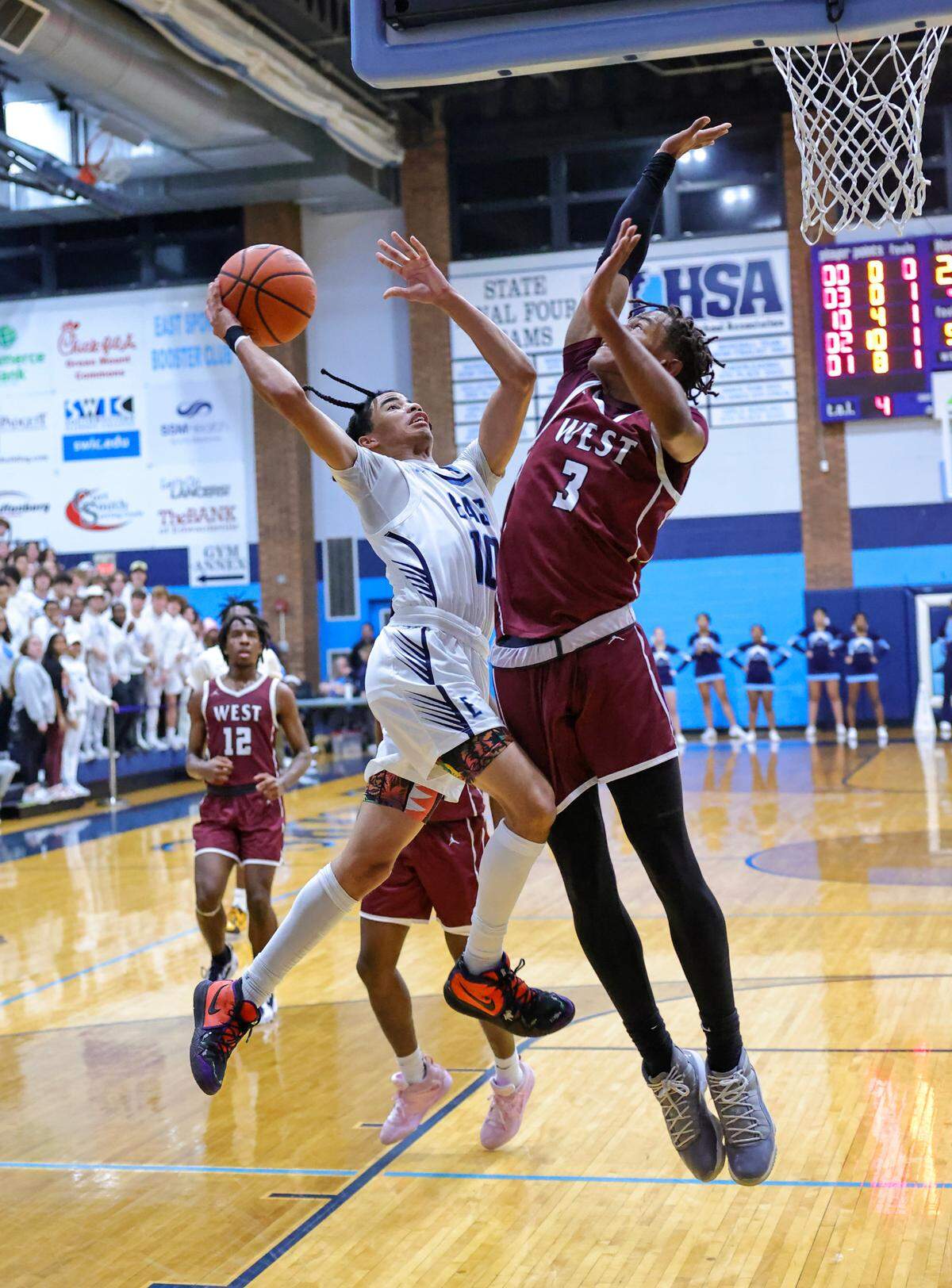 Belleville East’s Mason Mosley shoots over Belleville West’s Quincy Cotton during Friday night’s Southwestern Conference game. The Lancers ultimately posted a 66-57 victory.