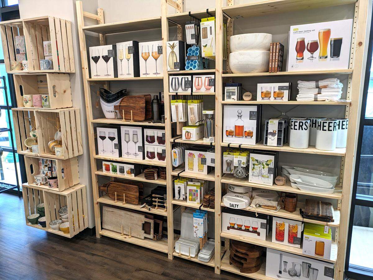 Shelves of drinkware, trays and other items at Toast & Table in O’Fallon
