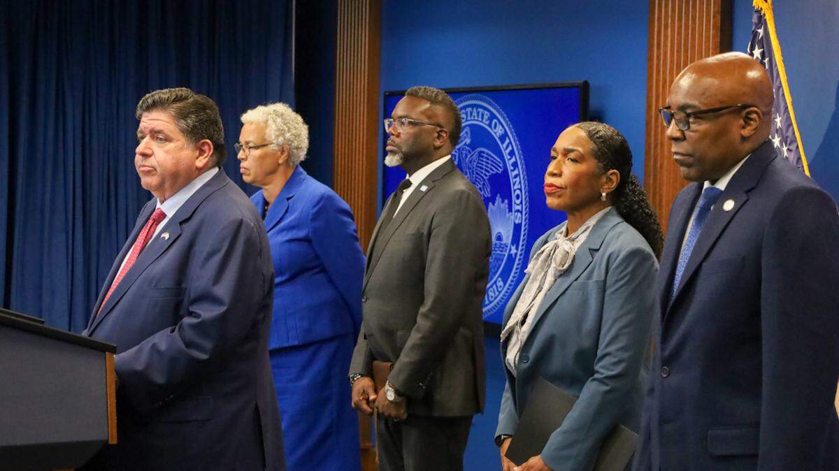 Gov. JB Pritzker, left, speaks at a Tuesday news conference to reporters ahead of potential military deployments in Chicago. Pictured behind him, from left to right: Cook County Board President Toni Preckwinkle, Chicago Mayor Brandon Johnson, Lt. Gov. Juliana Stratton and Attorney General Kwame Raoul.