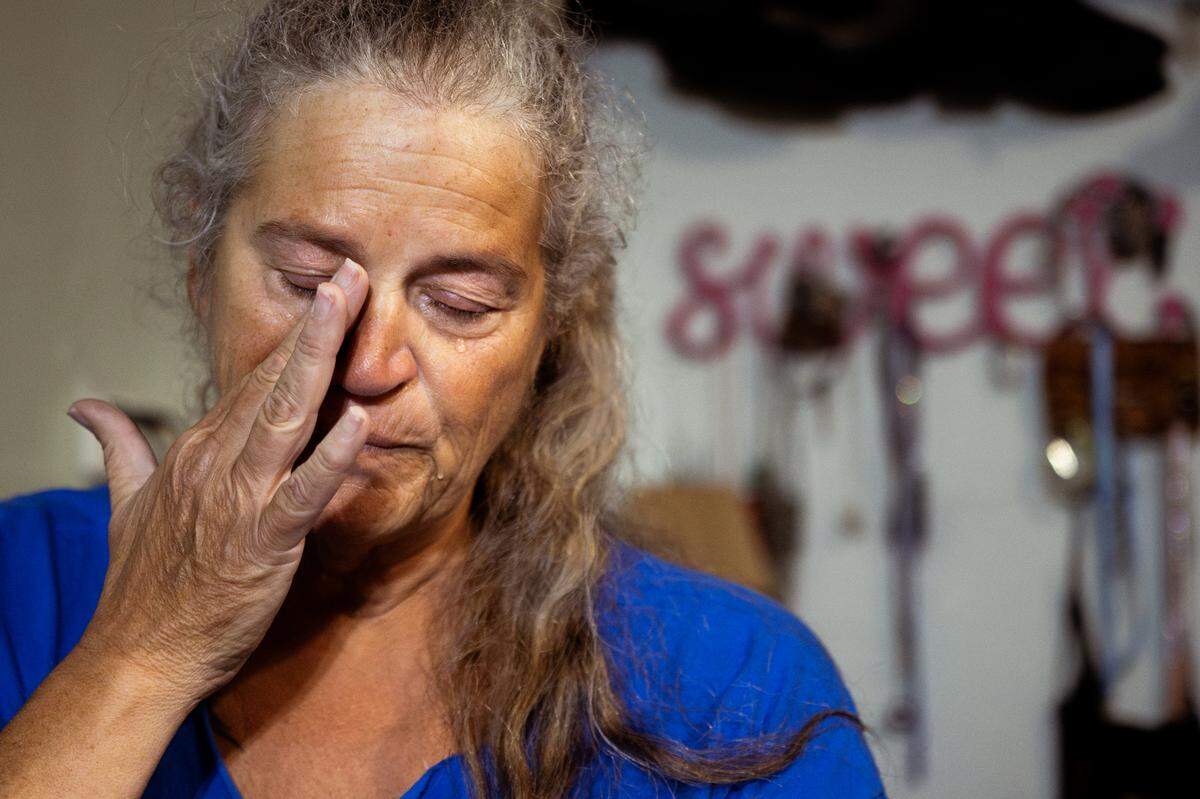 Tina Weber wipes away a tear while speaking about her life’s medical and personal hardships on Monday, Aug. 19, 2024, at her home in Collinsville, Illinois.