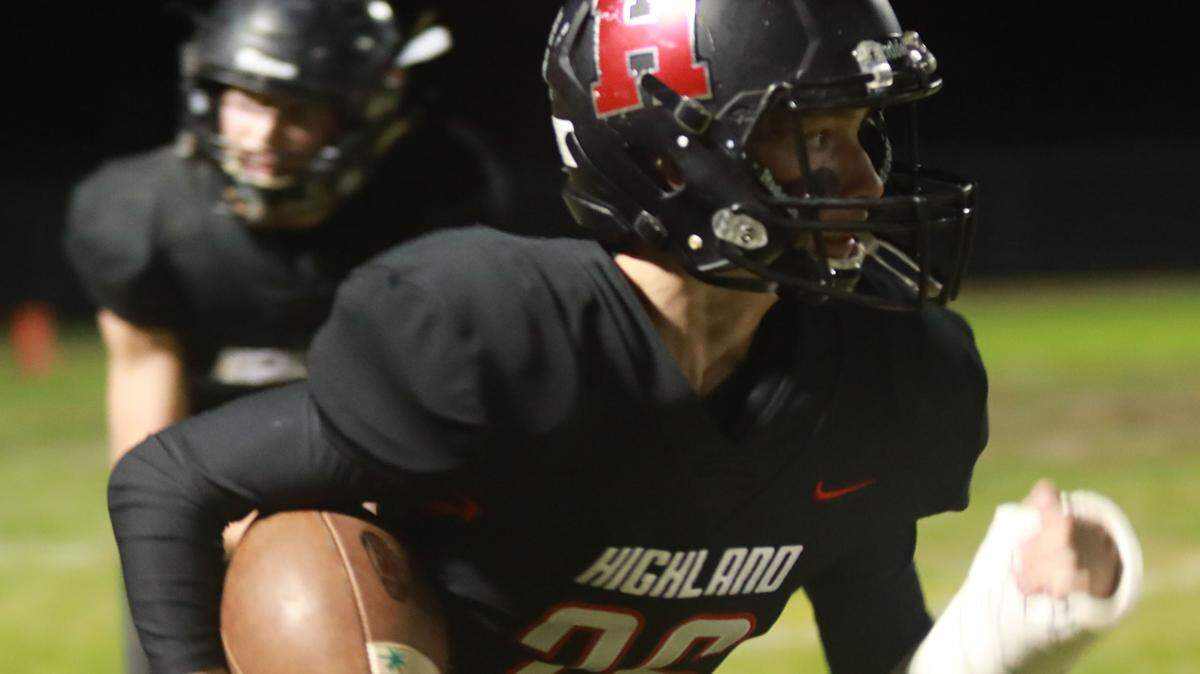 Drew Galbiati carries the ball for Highland Friday during a win over Jerseyville.