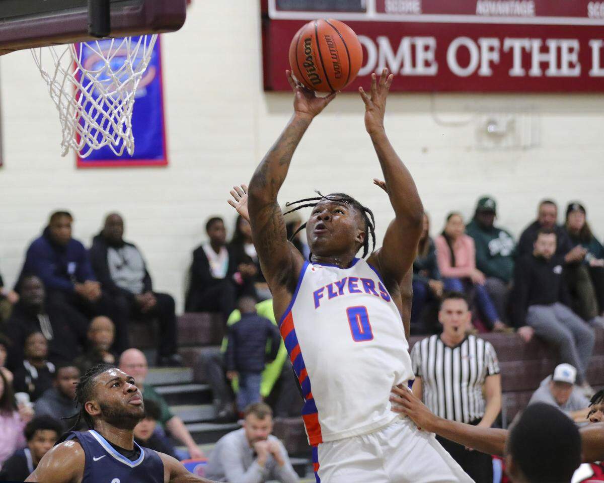 East St. Louis guard Macaleab Rich drives to the basket during Tuesday night’s Southwestern Conference game against Belleville East. The Flyers ultimately prevailed 72-71.
