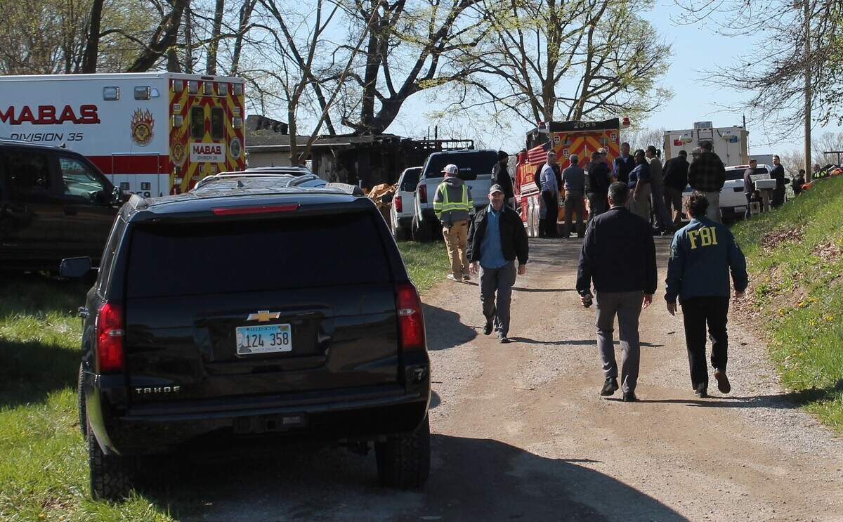 FBI agents arrive at a home at 8004 W. Kirsch Road in rural Troy after an explosion and fire on Easter Sunday resulted in the deaths of three people. One resident is facing charges related to the alleged manufacture of explosives.
