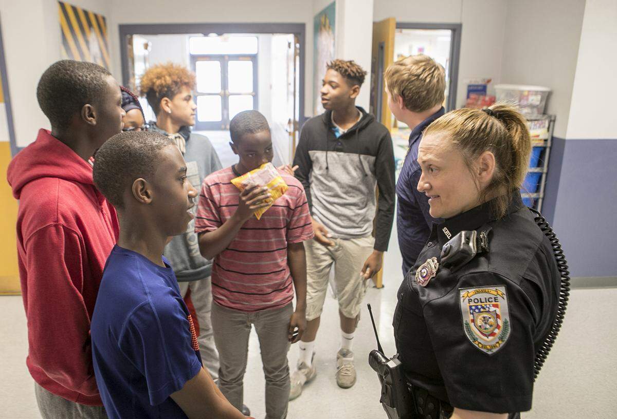 School resource officer Cheryl Venorsky talks with several of the older High Mount School students.
