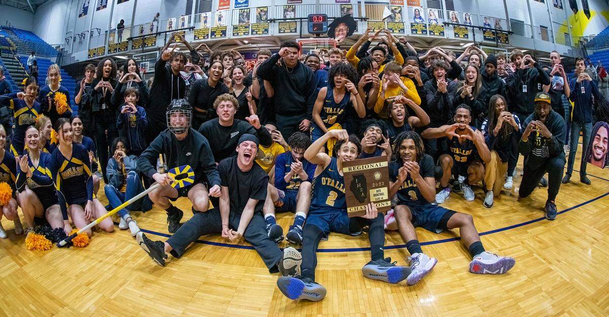 O’Fallon’s Jaeden Rush holds up the regional championship plaque and celebrates with his teammates and OTHS fans after Friday night’s IHSA Class 4A regional championship game at O’Fallon High School. The Panthers defeated Belleville East 52-50 to claim the regional crown.
