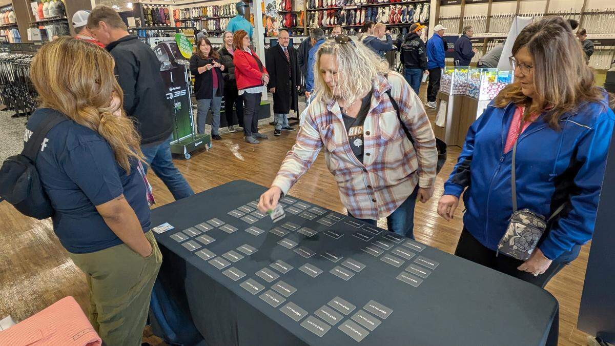 The first 100 customers at Golf Galaxy’s grand opening were offered free randomly selected gift cards as they entered the store.