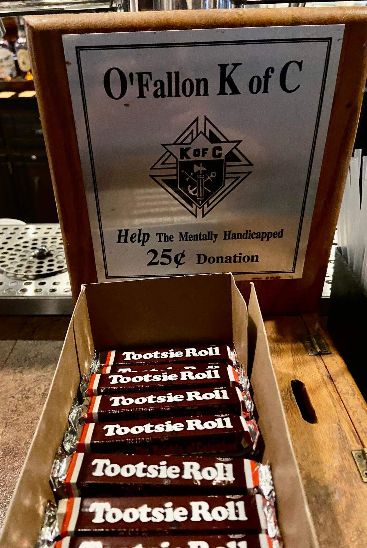 The O’Fallon Knights of Columbus sells Tootsie Rolls to support their developmentally disabled charity drive during the weekly fish fry.