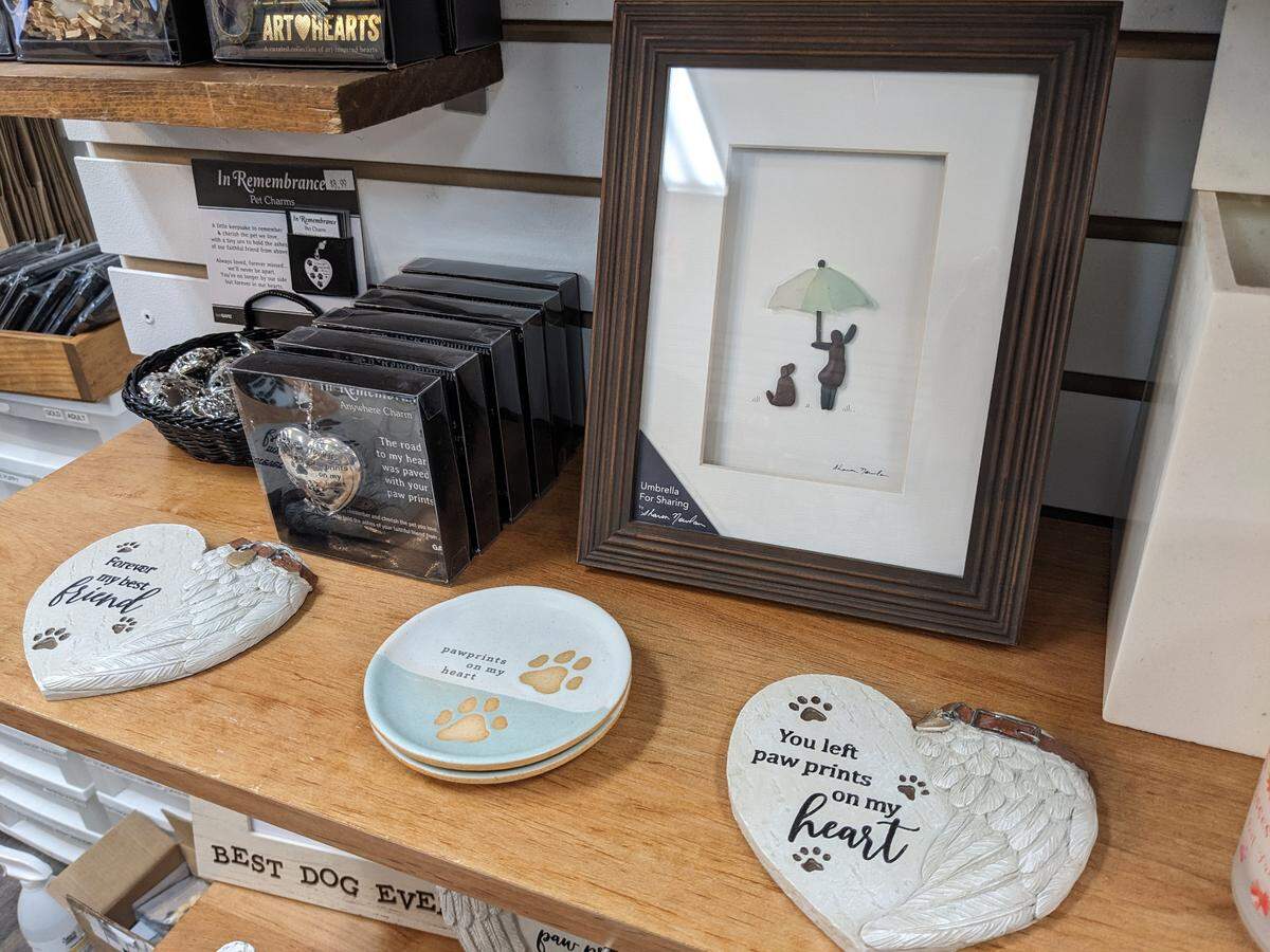 The “sad wall” at Muttley & Me includes decorative stones, picture frames and other items to honor a pet’s memory.
