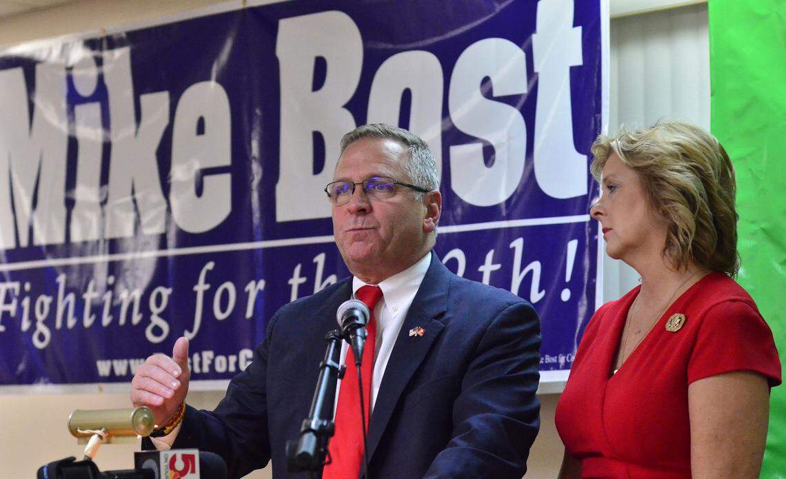U.S. Rep. Mike Bost, R-Ill., gestures as he speaks to his supporters with his wife, Tracy, beside him during an election night rally at the Elks Lodge in Murphysboro.