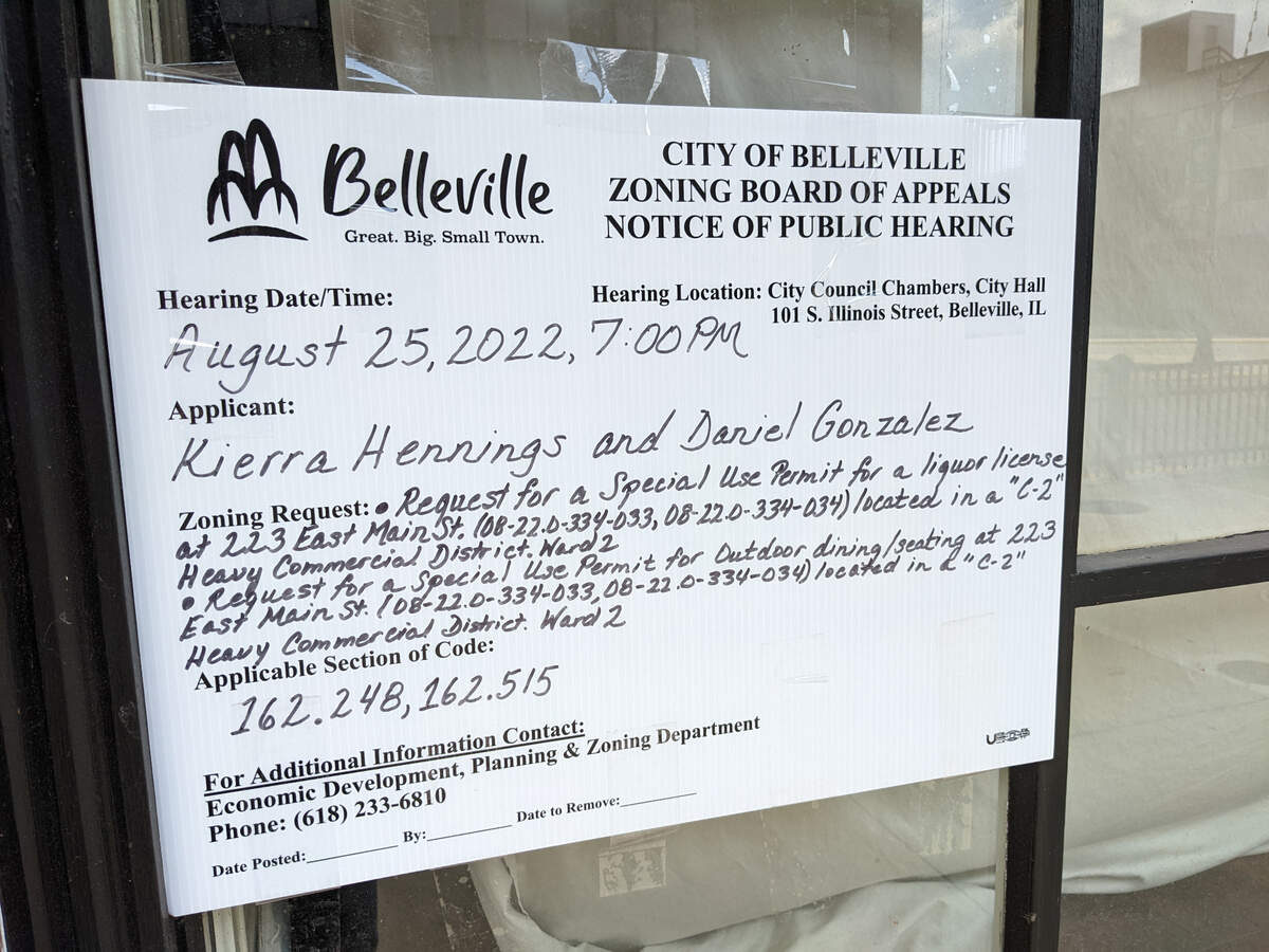A public hearing notice from the Belleville Zoning Board of Appeals posted at 223 E. Main St. in Belleville