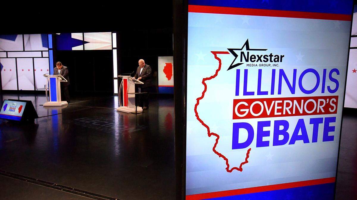 Illinois Gov. JB Pritzker, left, and his Republican challenger state Sen. Darren Bailey, right, pause before the Illinois Governor’s Debate on the stage in Braden Auditorium at the campus of Illinois State University in Normal, Ill., Oct. 6. (Ron Johnson/Illinois State University via AP, Pool)