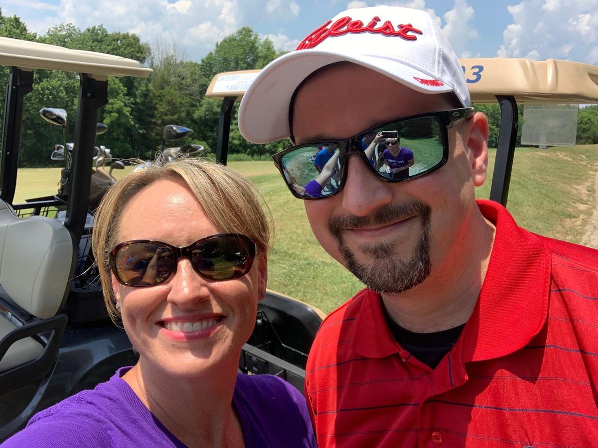 Rachel Budko, founder of PEG Can Help, a nonprofit organization that raises money to fight domestic violence, is pictured on June 20 with her husband, Mike, at a golf tournament.