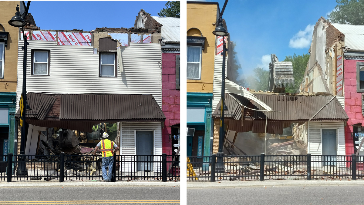 Claws on the giant bucket of a track hoe pull down the facade of a 2 1/2-story brick storefront covered with tan siding on Wednesday at 1013 W. Main St. in Belleville. The building was constructed in the 1860s.