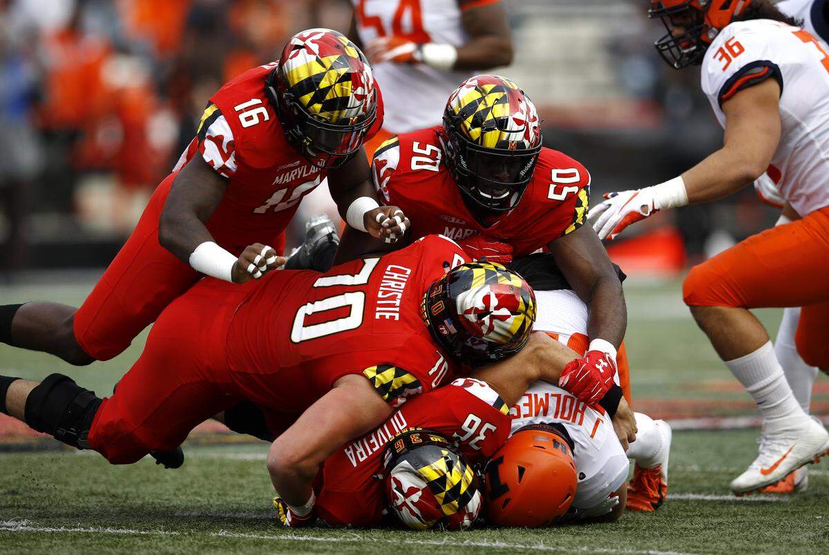 A group of Maryland defenders tackle Illinois wide receiver Jordan Holmes as he rushes the ball in the first half of an NCAA college football game, Saturday, Oct. 27, 2018, in College Park, Md. (AP Photo/Patrick Semansky)