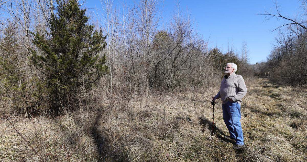 Gene Canavan explores a wooded area behind Mount Hope Cemetery over the winter. The longtime Belleville resident has asked officials to move a planned solar farm to a different location.