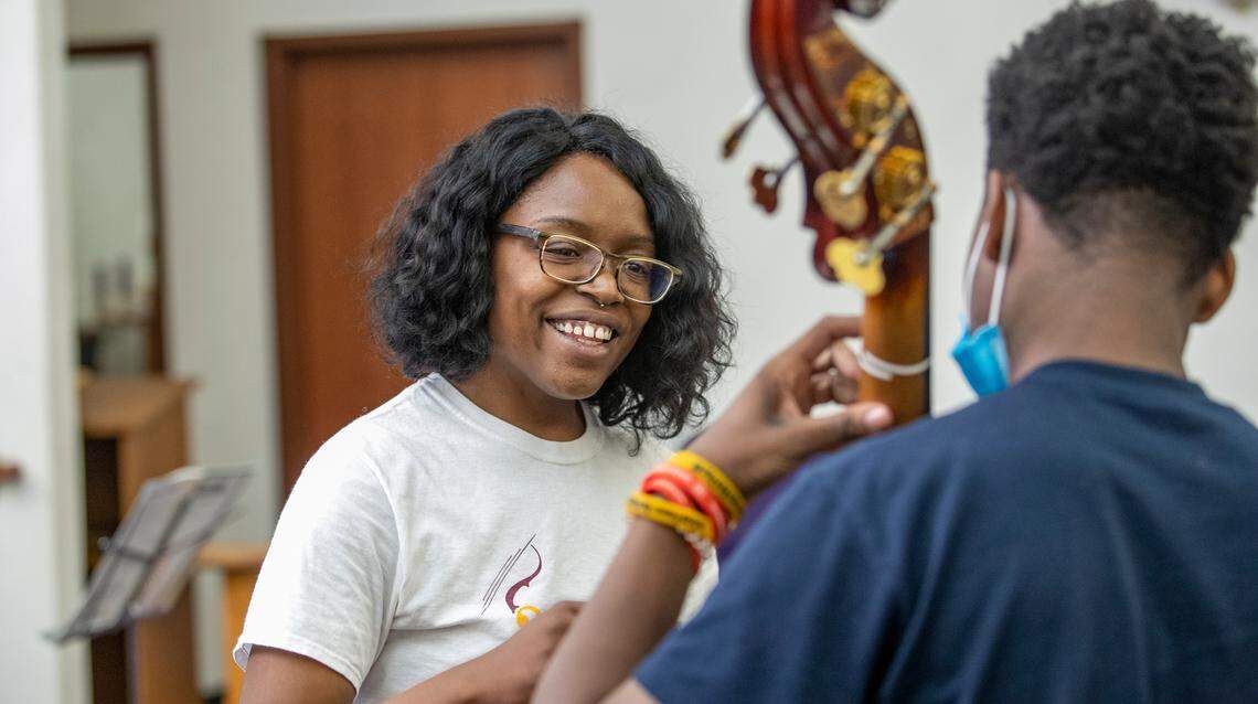 Rosalind Denise Rogers works with Carl Hill during a music lesson.