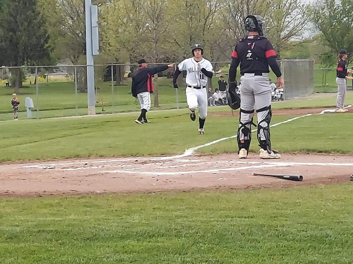 HIghland’s Luke Darling comes home to score a run in the first inning of a Mississippi Valley Conference game against Triad on Tuesday, May 2, at Glik Park in Highland. The Knights rallied late to defeat the Bulldogs 5-2.
