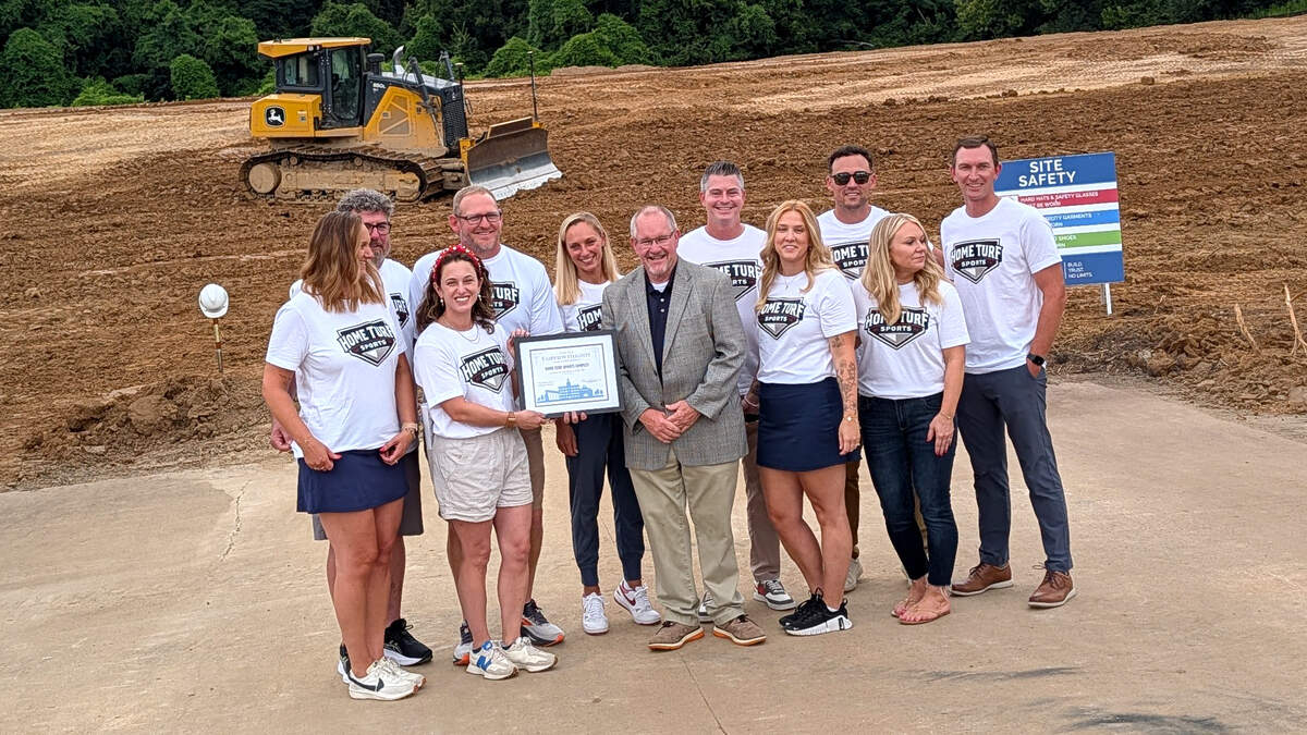 Fairview Heights Mayor Mark Kupsky presents a certificate on behalf of the city to the owners of Home Turf Sports Complex at its July 9, 2026, groundbreaking event.