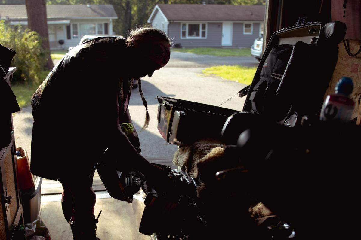 Tina Weber packs her belongings in the trunk of her motorcycle, “Nighthawk,” before going out on a morning ride on Sunday, July 14, 2024, in Collinsville, Illinois.