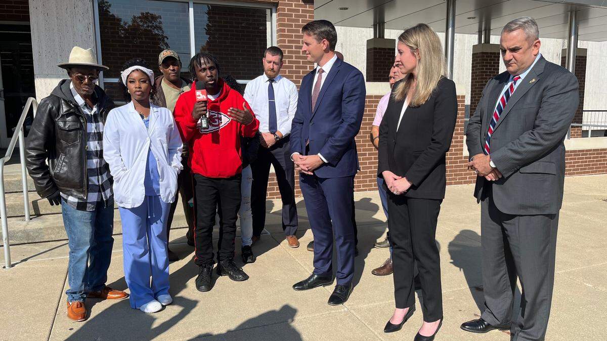 Madison County State’s Attorney Tom Haine, center, and Assistant State’s Attorneys Lauren Maricle and Mike Stewart listen to Darrell Burnett talking to reporters in Edwardsville about the murder trial of Roger D. Sutton Jr. Sutton was found guilty on Thursday of murdering Burnett’s mother, Patrenia “Trina” Butler-Turner, in 2013.