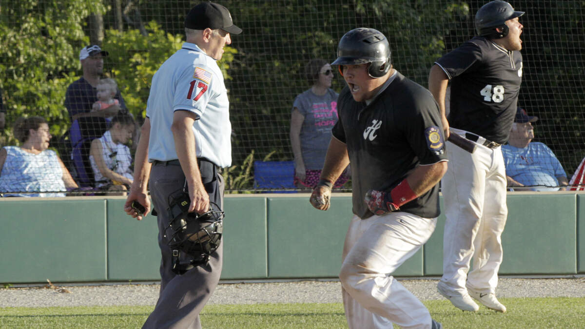 Colten Knebel is pumped as he crosses the plate with Highland’s second run on Wednesday in Post 439’s game at Alton. He scored in the sixth inning off a triple by Garrett Marti. In the background, Colten’s twin brother, Dylan, jumps and yells encouragement as Marti rounds the bases.