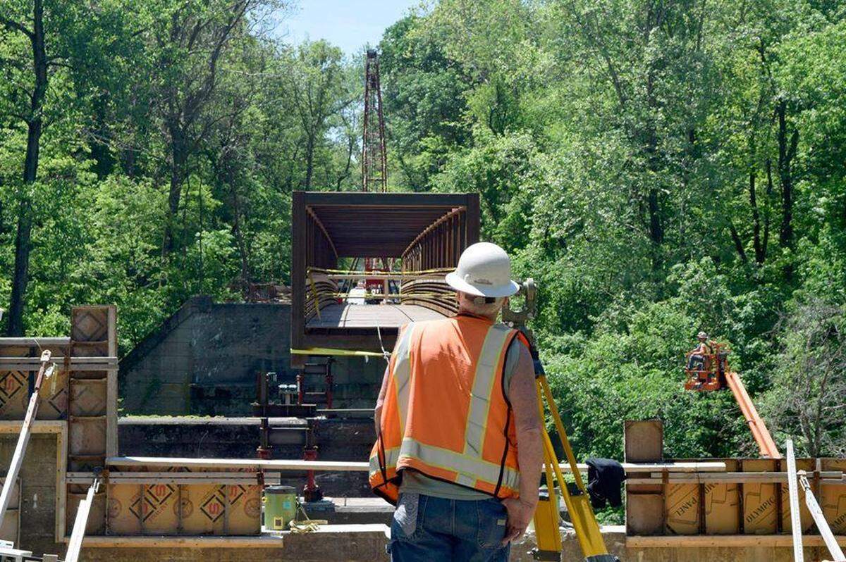 A construction worker helps build one portion of a bridge along the extended Goshen Trail in May 2019.