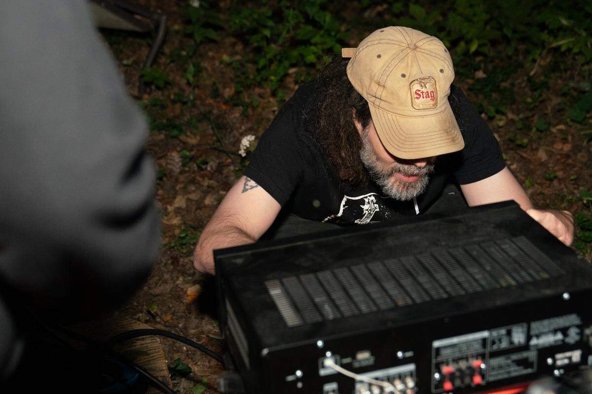 As a DIY venue with no paid staff, owner Gabe Kimme has to fix the PA system himself between shows.
