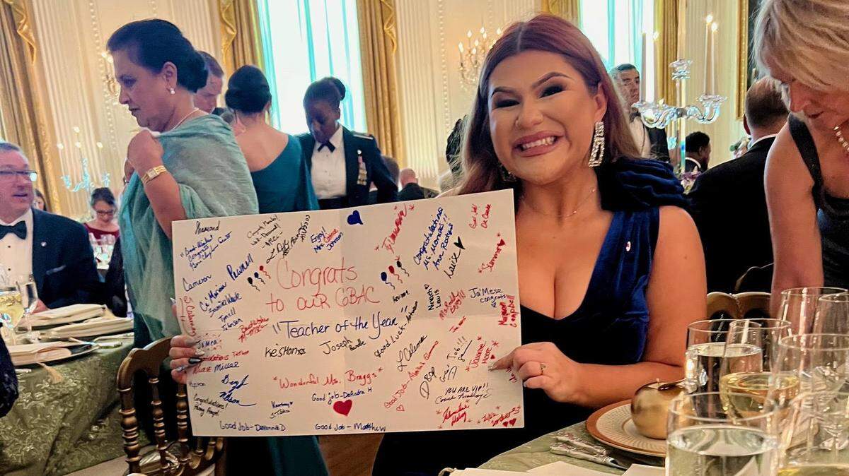 Briana Morales, the 2023 Illinois Teacher of the Year from East St. Louis School District 189, holds a letter signed by her students and fellow staff at Gordon Bush Alternative Center while attending the first-ever state dinner for educators at the White House on May 2, 2024.