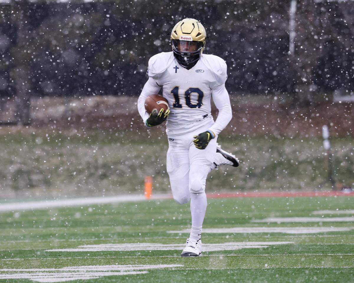 Althoff’s Dierre Hill Jr. carries the ball during the Crusaders’ 57-14 win over Lena-Winslow for the IHSA Class 1A title at Hancock Stadium on the campus of the Illinois State University.
