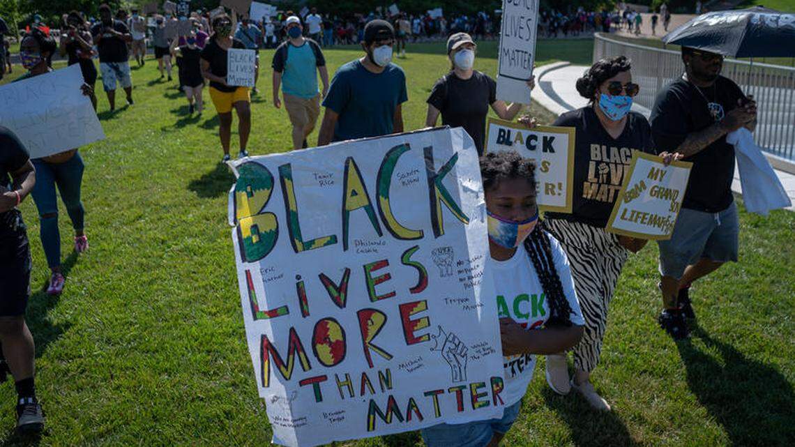 About 100 demonstrators, many of them children, walk onto the Arch grounds Sunday afternoon to protest police violence against black people. It was just one of several such protests over the weekend.