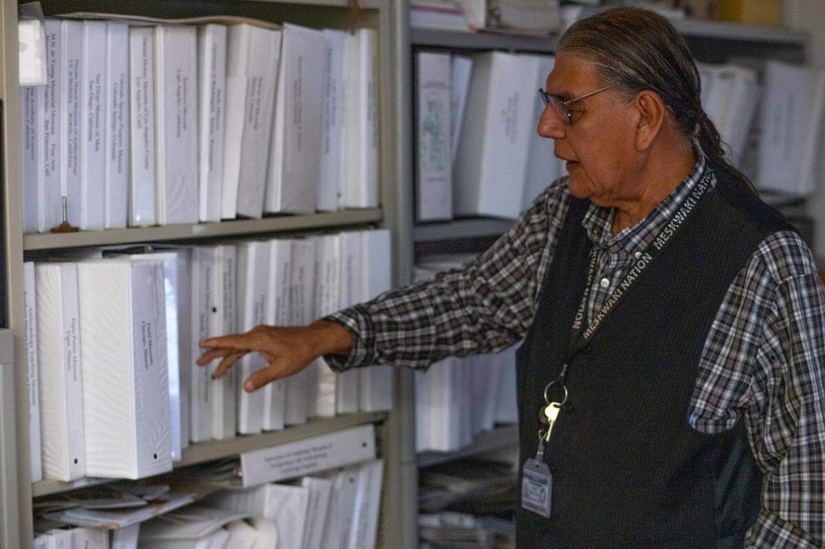 Jonathan Buffalo points to binders containing information on museums whose inventories he believes include ancestors of the Meskwaki Nation, also known as the Sac & Fox Tribe of the Mississippi in Iowa.