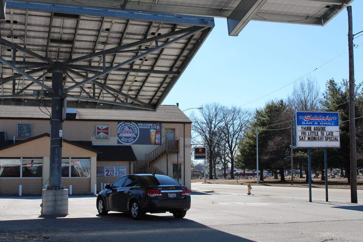Pole-mounted canopies with solar panels in the parking lot of Eddie’s Lounge, also known as Eddie’s Bar & Grill, cause many drivers on Nameoki Road to do double takes.