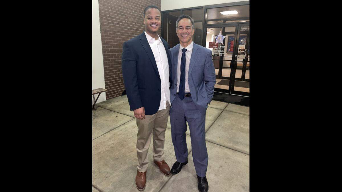 Willie L. Matthews Jr., of Belleville, left, poses with his attorney, Robert Bas, after being released from the Madison County Jail late Thursday night. A jury had just found him not guilty of murder.