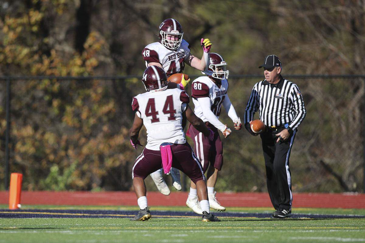 Red Bud’s Lucas Schwartzkopf and Devin Hall celebrate after Schwartzkopf’s interception return for a touchdown interception during during an IHSA Class 2A second round playoff game against Althoff. The Musketeers ultimately fell to the Crusaders 26-14.
