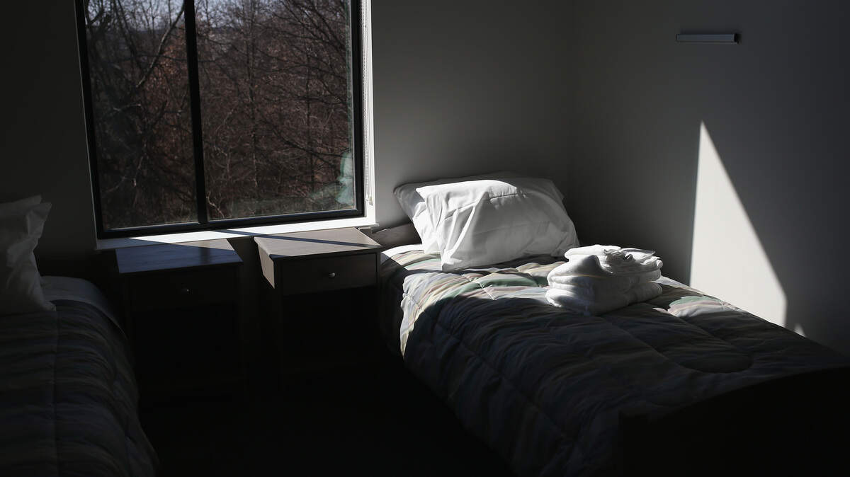 A bed with sheets and a pillow.