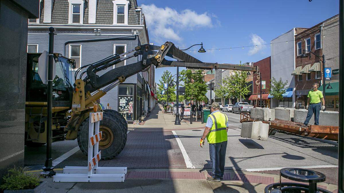 City of Belleville workers installed barriers on Friday morning to close portions of three downtown streets so restaurants and bars could expand outdoor dining.