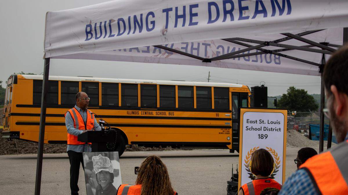 Arthur R. Culver, superintendent of East St. Louis School District 189, addresses an audience outside the Illinois Central School Bus Garage on Thursday, June 12, 2025. Behind him is one working example of District 189’s new electric school bus, which promises to reduce air and sound pollution produced by typical gasoline-powered school buses.