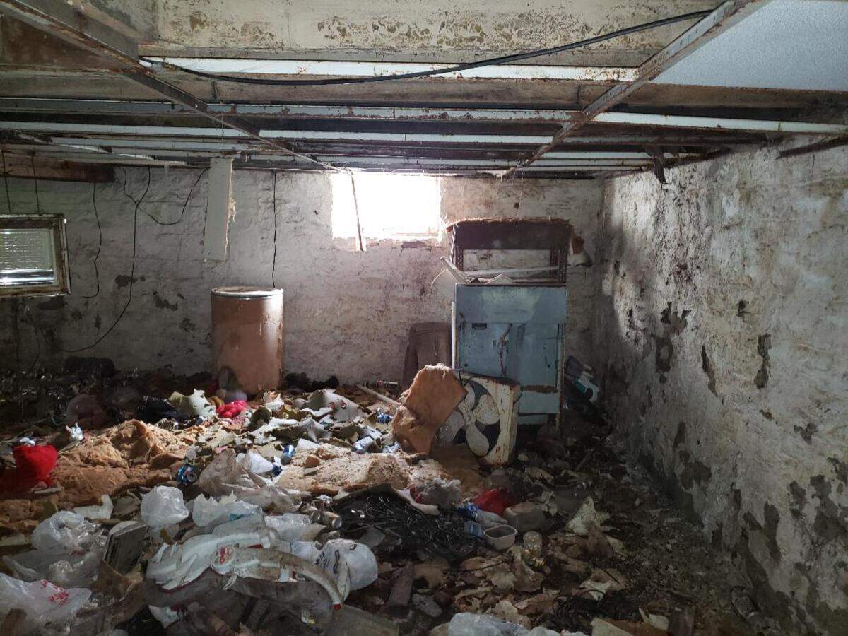 This “before” photo shows the trash-filled basement of a home at 313 S. Ninth St. in Belleville. It has been cleaned out and renovated by Belleville Community Development Corp.