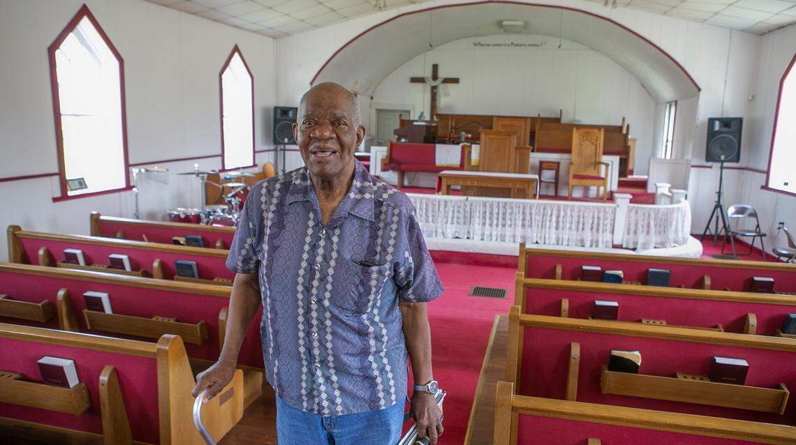 George McShan, secretary for Quinn Chapel Church in Brooklyn, Illinois, stands inside the sanctuary of the church.