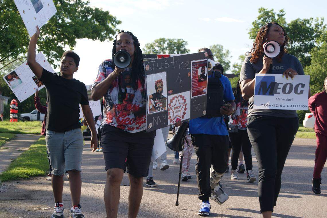 La’Tatia Stewart (center) marches on Bond Avenue in East St. Louis on Saturday, which was the one-year anniversary of the day her son, Gregory Stewart, died. He was shot outside 2408 Bond Avenue.