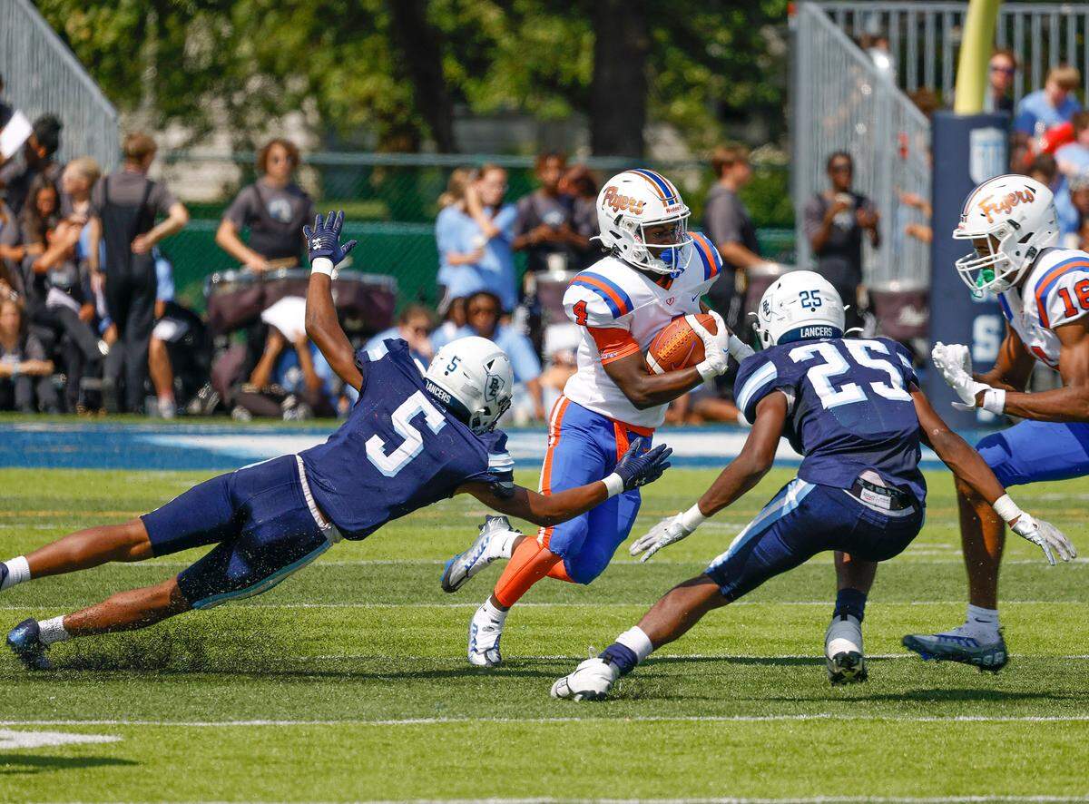 East St. Louis wide receiver John Daily runs the ball against host Belleville East during a Southwestern Conference game Saturday. The Flyers went on to post a 57-0 victory.