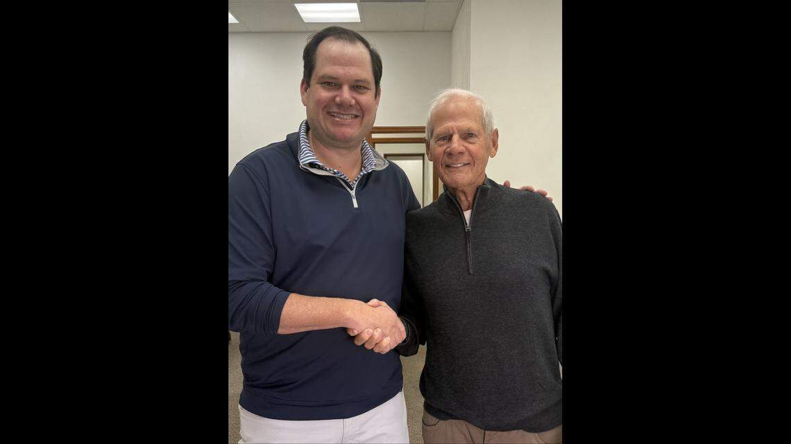 Attorney Mark Millton, left, poses for a handshake with retired attorney Jim Mendillo, who recently sold him the building at 122 W. Main St. in Belleville. Milton is expanding his practice from Missouri to Illinois.