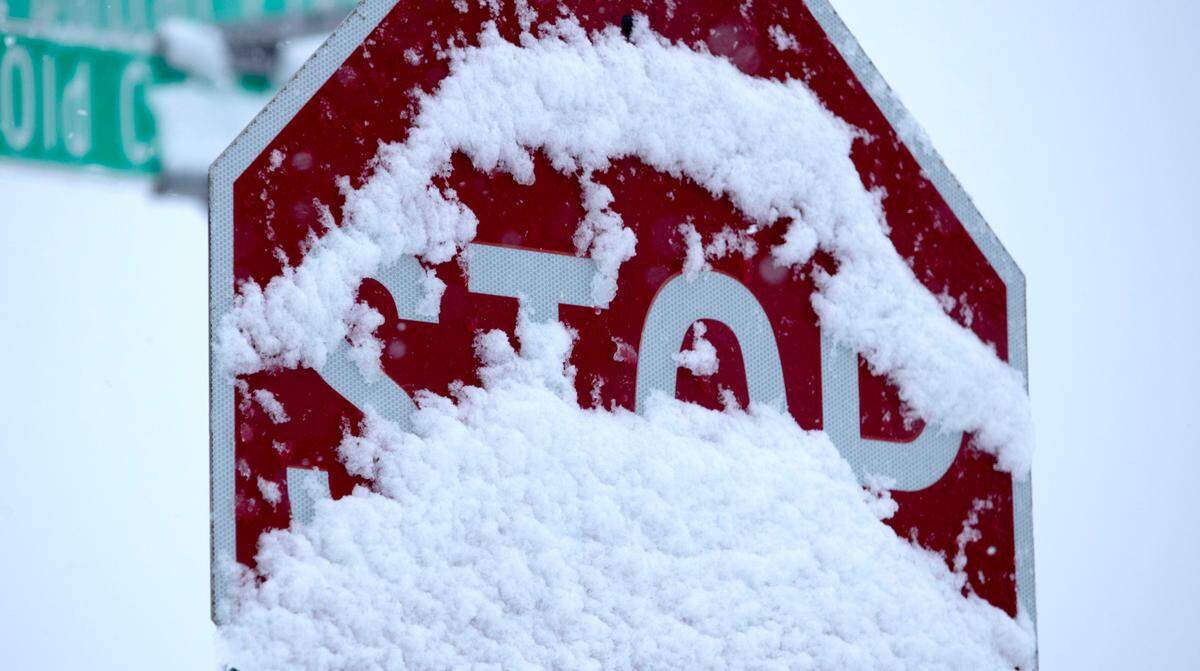Snow partially covers a stop sign at the intersection of Central Park Plaza and Old Collinsville Road in Belleville. The winter storm that hit the metro-east was far less problematic than originally projected.