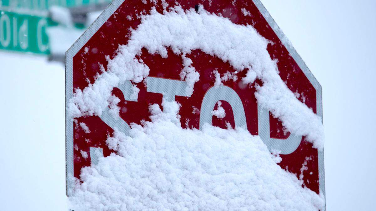 Snow covering stop sign during storm last winter.