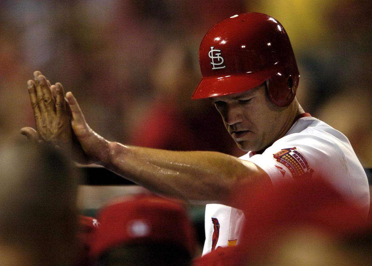 St. Louis Cardinals’ Scott Rolen is congratulated in the dugout after scoring in the fifth inning on a single by Juan Encarnacion against the Chicago Cubs during their baseball game on Friday, Aug. 25, 2006, at Busch Stadium in St. Louis. (AP Photo/Kyle Ericson)
