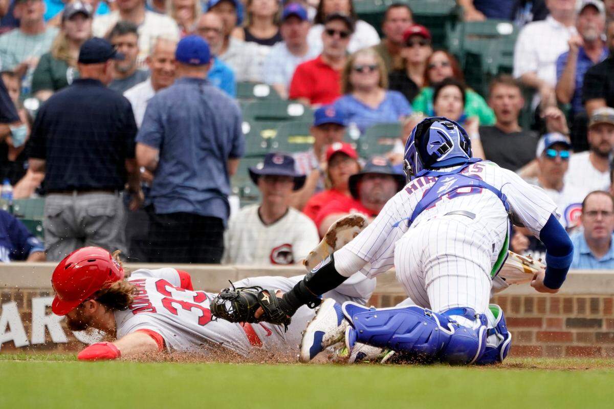 Chicago Cubs catcher P.J. Higgins tags Brendan Donovan of the St. Louis Cardinals out at home after Donovan tried to score on Corey Dickerson’s fielder’s choice during the fourth inning Thursday at Wrigley Field in Chicago. The Cardinals and Cubs will face off in June next season in London.