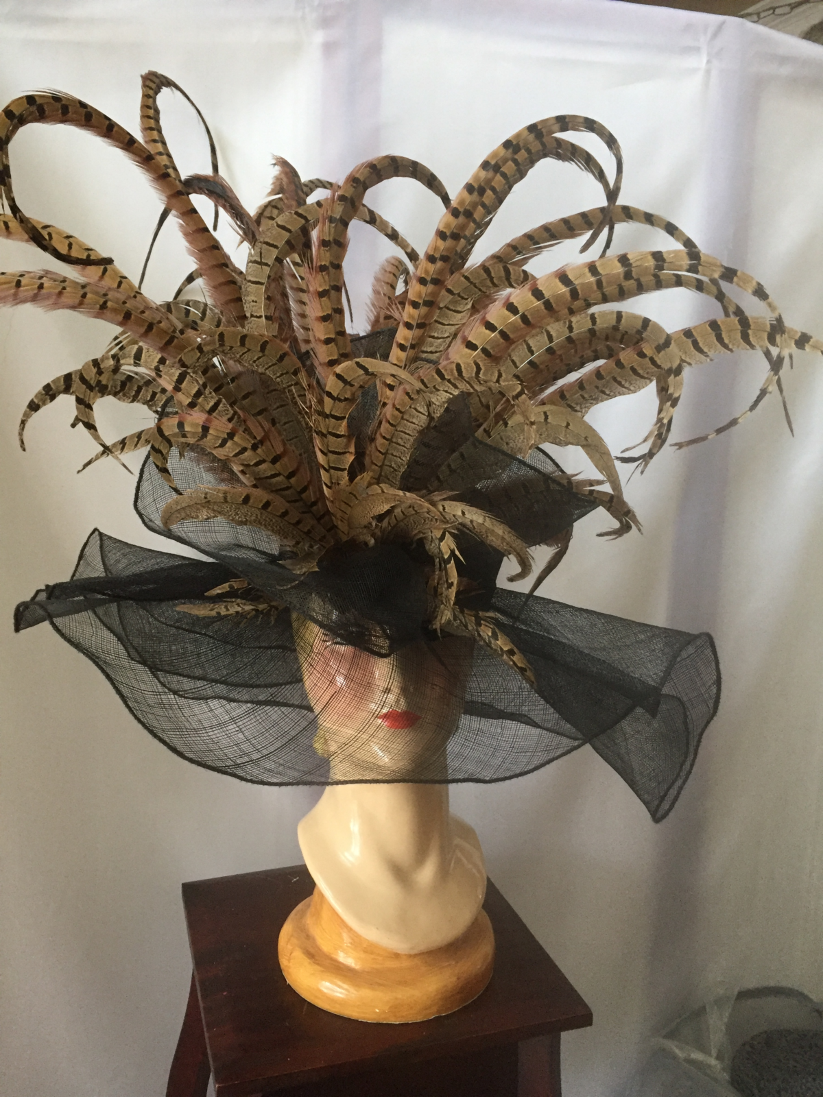 This 2-foot-tall hat, designed by Dianne Isbell, is made of three layers of black, ruffled sinamay topped with pheasant feathers. It recently was selected as “Best Hat” out of 500 hats worn to a fundraiser at Naples Botanical Garden in Florida.